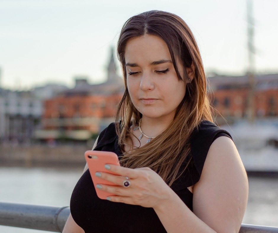 Woman mesmerized looking at her phone