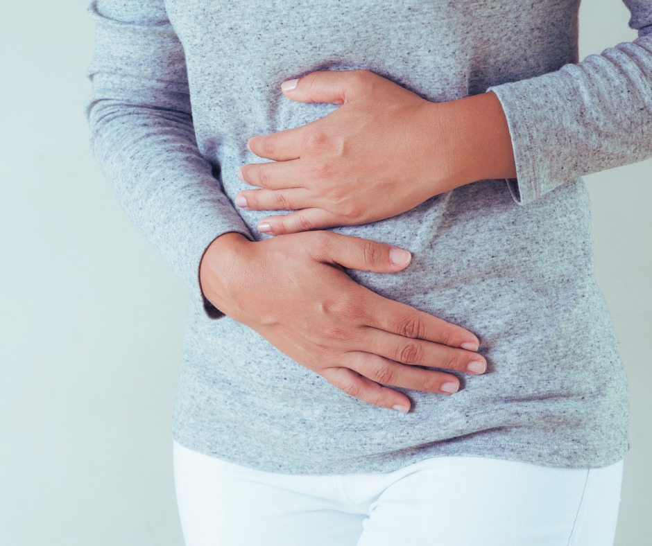 Women holding bloated belly